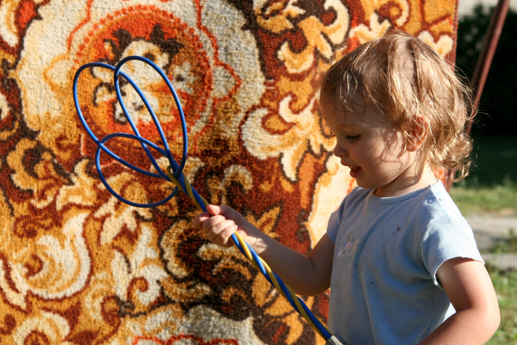 Beat rugs to loosen embedded dust.